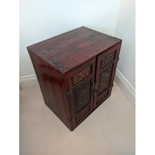 288 - A pair of Chinese red and gold lacquered cabinets, each with a pair of panelled doors, 57cm high,  5... 