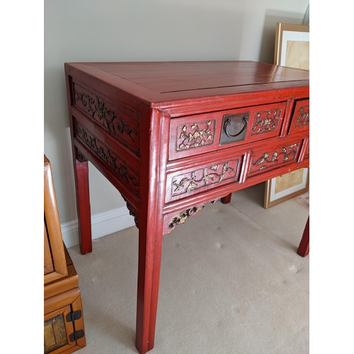 299 - A Chinese red lacquered, carved and gilt desk with two drawers on square legs, 76cm high, 95cm wide
... 