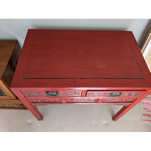 299 - A Chinese red lacquered, carved and gilt desk with two drawers on square legs, 76cm high, 95cm wide
... 