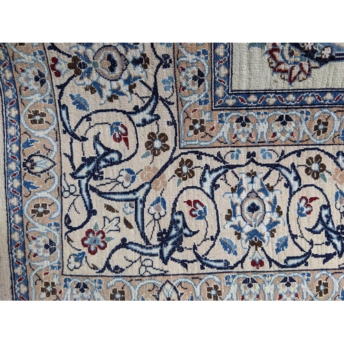 306 - A central Persian rug with central medallion and scrolled vines on a cream ground, 129cm x 207cm
Loc... 