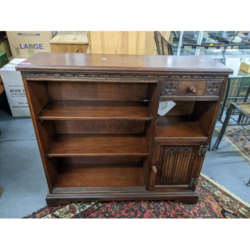 356 - A mid 20th century oak Old Charm bookcase, 87.5 h x 93w, together with a pair of oak circular topped... 