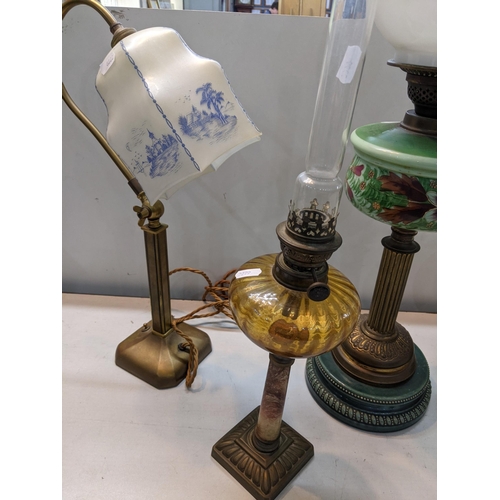 101 - A late 19th/early 20th century oil lamp together with two others along with a brass lamp
Location:RO... 