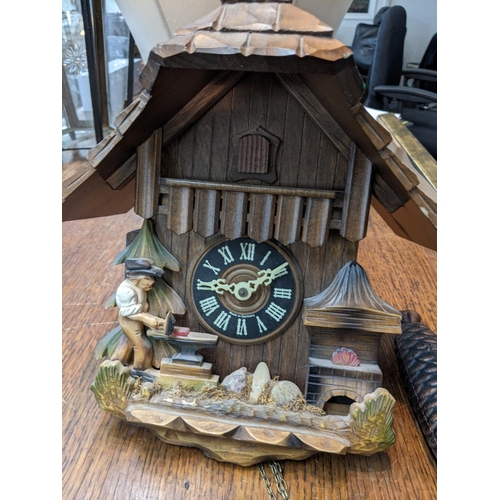 106 - A vintage Black Forest Cuckoo clock in the style of architectural form, together with two weights
Lo... 