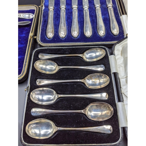 110 - A set of six silver coffee spoons, 50.5g and silver handled knives along with other flatware
Locatio... 