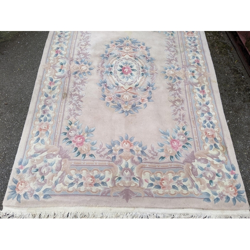 113 - A Chinese rug having a central motif and a floral design, 250cm x 171cm
Location:G