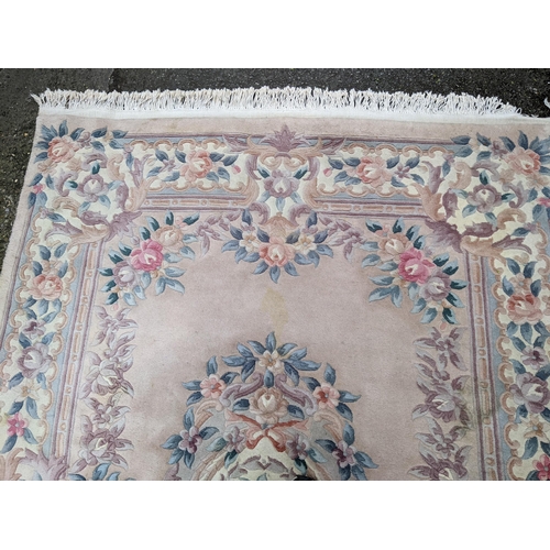 113 - A Chinese rug having a central motif and a floral design, 250cm x 171cm
Location:G