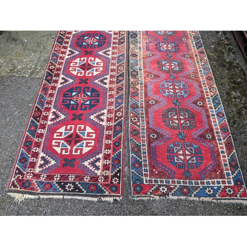 114 - A matched pair of Persian hand woven runners having a red ground with repeating motifs, 284cm x 72cm... 