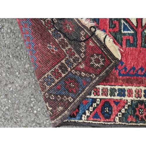 114 - A matched pair of Persian hand woven runners having a red ground with repeating motifs, 284cm x 72cm... 