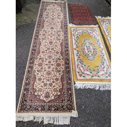 115 - Four mixed rugs to include a pair of Chinese yellow ground rugs, 128cm x 61cm, an Indian beige groun... 