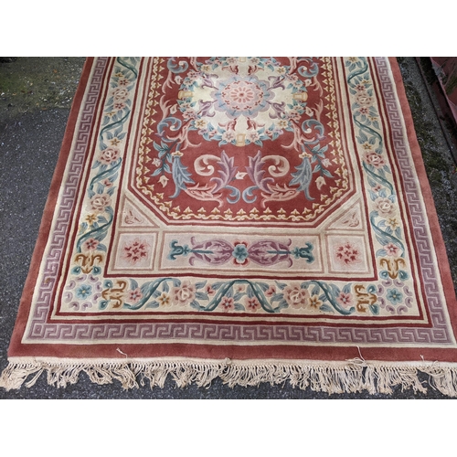 116 - A Chinese red ground rug having a central motif and multi-guard borders, 280cm x 182cm
Location:G