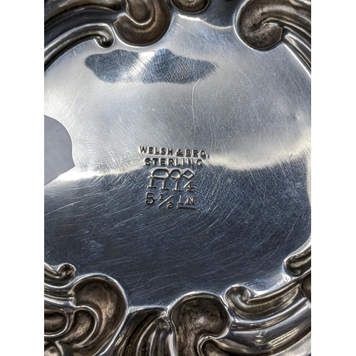 168 - An American Welsh & Bro sterling silver floral and C scroll embossed dish, with initials to the cent... 