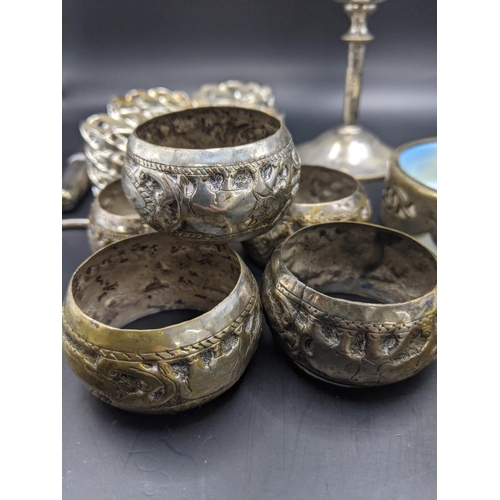 182 - Indian white metal napkin rings, 78.5g, together with a set of four silver plated napkin rings, a si... 