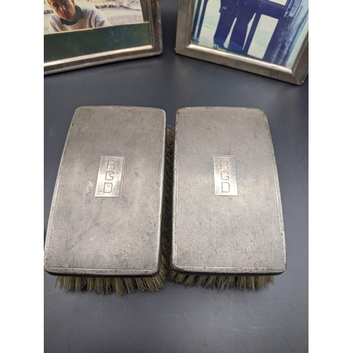 188 - Two silver photo frames, one hallmarked Birmingham 1903, together with two silver dressing table bru... 