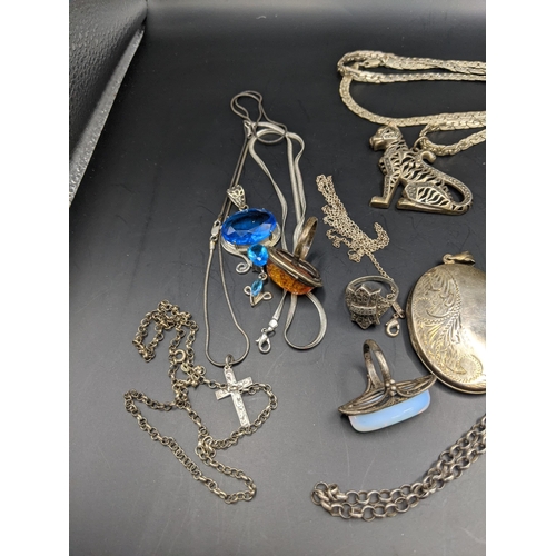 189 - A mixed lot of silver, white metal and others to include a large silver cross pendant set with ruby ... 