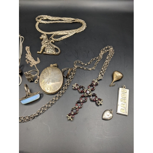 189 - A mixed lot of silver, white metal and others to include a large silver cross pendant set with ruby ... 