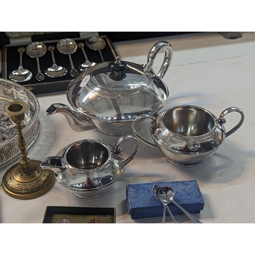 195 - Silver plate to include a tea set, flatware, silver handled knives, a magnifying glass and other ite... 