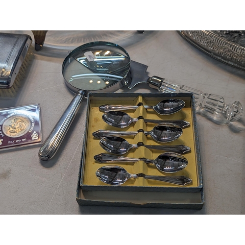 195 - Silver plate to include a tea set, flatware, silver handled knives, a magnifying glass and other ite... 