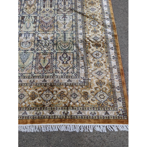 204 - A handwoven silk Turkish carpet having geometric designs with multi guard borders and tasselled ends... 