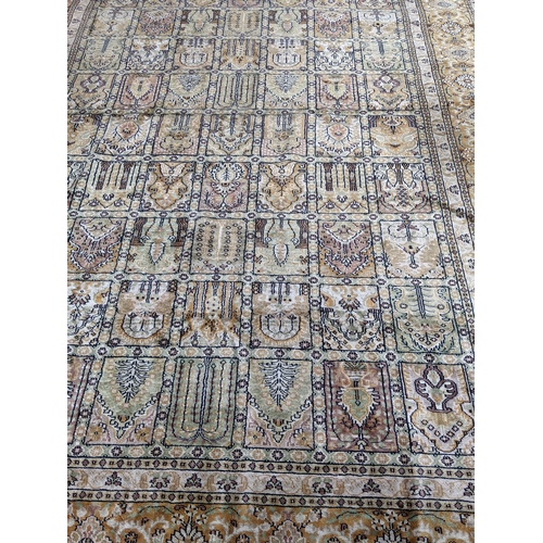 204 - A handwoven silk Turkish carpet having geometric designs with multi guard borders and tasselled ends... 