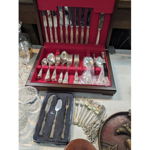 235 - A large mixed lot to include silverplated trays and others, a canteen of cutlery porcelain figurines... 