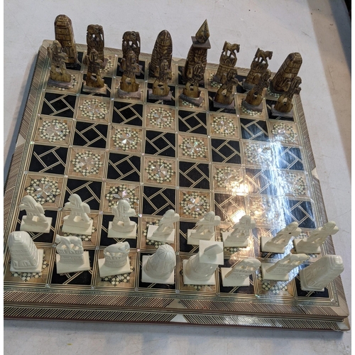 239 - An Egyptian chess board parquetry inlaid with mother of pearl and bone
Location:A2M