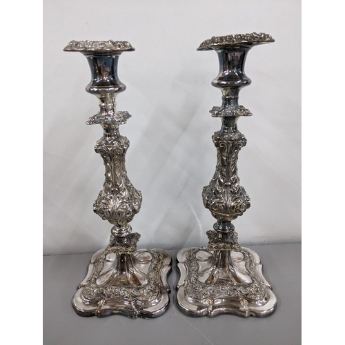 252 - A pair of 19th century silver plated candlesticks having scroll and vine decorated columns
Location:... 