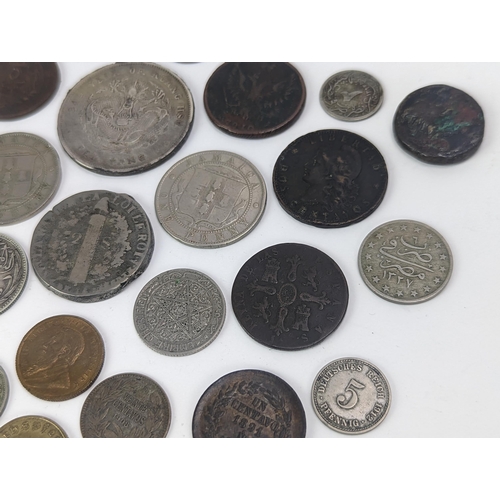 26 - A mixed group of 19th century and other world coinage to include a Japanese Meji one yen, 1848 Isabe... 