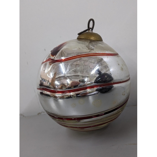 314 - A large Kugel glass Christmas ornament having a silver and red swirl design, 18cm high
Location: 9.3