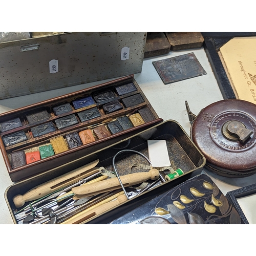 320 - A mixed lot to include an early 20th century travel stationary A/F, brass lamp, vintage tins, Egypti... 