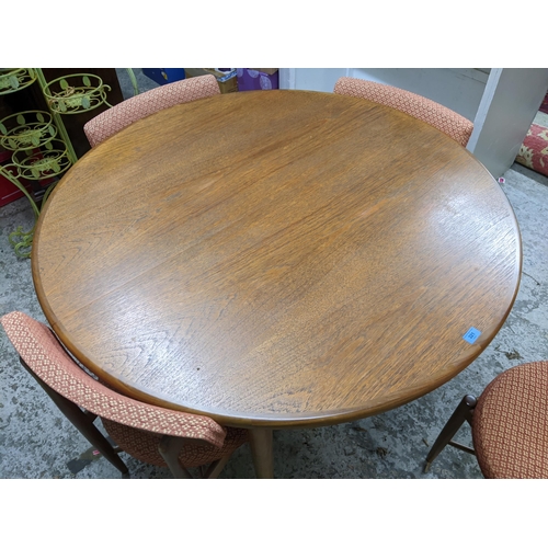 321 - A mid 20th century G-plan teak extending dining table, and four chairs, designed by Victor Wilkins
L... 