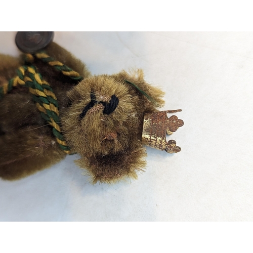 388 - A 1940's miniature Schuco Promotional teddy bear for BP (British Petroleum), wearing a crown and wit... 