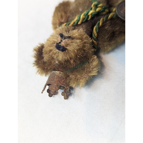 388 - A 1940's miniature Schuco Promotional teddy bear for BP (British Petroleum), wearing a crown and wit... 