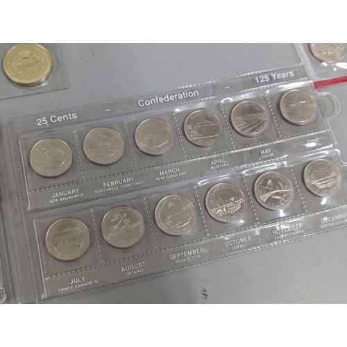 39 - A collection of North American commemorative coins to include a 1964 Canada Charlottetown silver dol... 