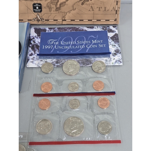 39 - A collection of North American commemorative coins to include a 1964 Canada Charlottetown silver dol... 