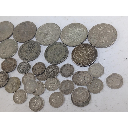 42 - A group of British pre-1947 coinage to include Half-Crowns, Florins, Sixpence, and threepence, 161.2... 