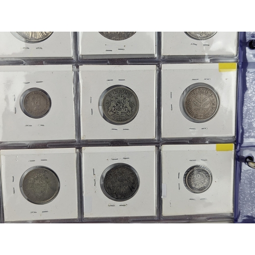 46 - An album of mixed world silver coinage to include a 1912 British Trade Dollar, 1861-1908 Chinese Don... 