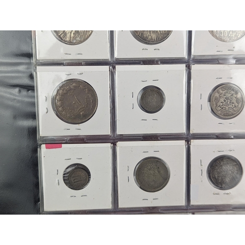 46 - An album of mixed world silver coinage to include a 1912 British Trade Dollar, 1861-1908 Chinese Don... 