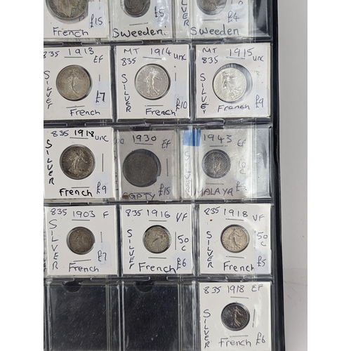 46 - An album of mixed world silver coinage to include a 1912 British Trade Dollar, 1861-1908 Chinese Don... 