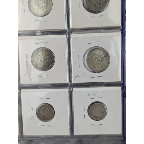 46 - An album of mixed world silver coinage to include a 1912 British Trade Dollar, 1861-1908 Chinese Don... 