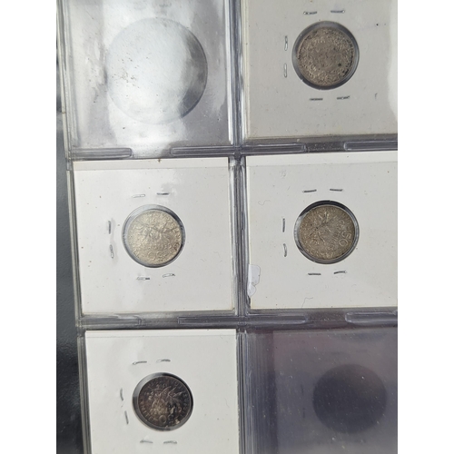 46 - An album of mixed world silver coinage to include a 1912 British Trade Dollar, 1861-1908 Chinese Don... 