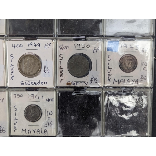 46 - An album of mixed world silver coinage to include a 1912 British Trade Dollar, 1861-1908 Chinese Don... 