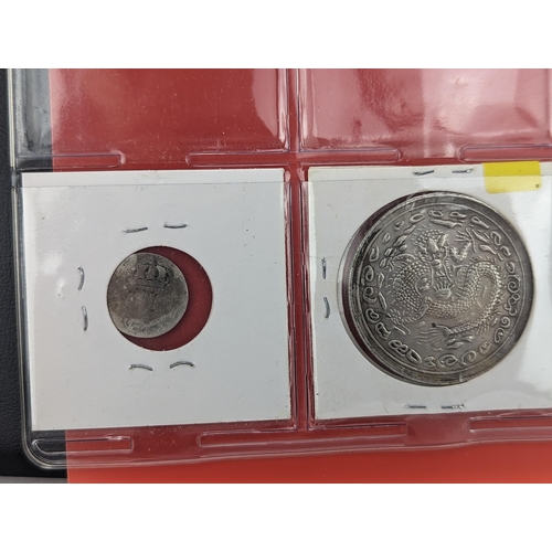 46 - An album of mixed world silver coinage to include a 1912 British Trade Dollar, 1861-1908 Chinese Don... 