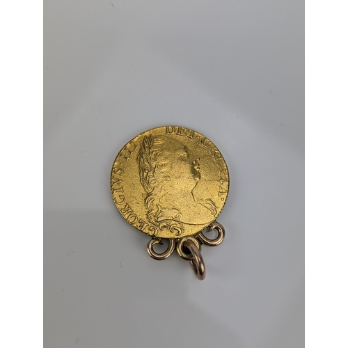 49 - UK - George III (1760-1820) Guinea dated 1774 having attached yellow metal mount, 9.4g Location:CAB6