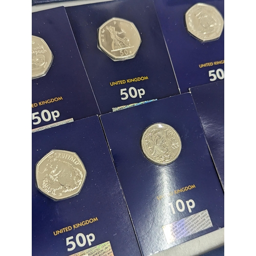 64 - A mixed collection of coins to include 2017 Beatrix Potter 50p coin collecting pack, 2018 coin colle... 