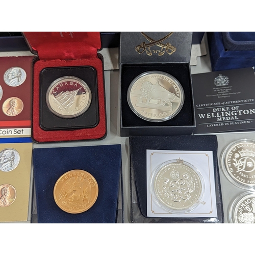 65 - A large group of coins to include Westminster Elizabeth II and Prince Philip Numis proof crowns, Ico... 