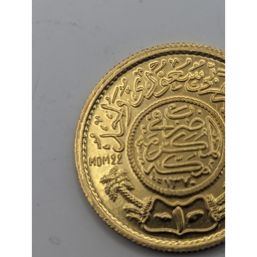 76 - A jewellers restrike 'Commercial Copy' of a Saudi Arabian one Gunagh, testing as 22ct gold, 7.9g Loc... 