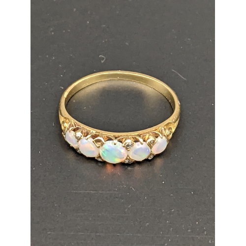 89 - A yellow metal ring set with opals, tested as 18ct, total weight 2.0g
Location:CAB2