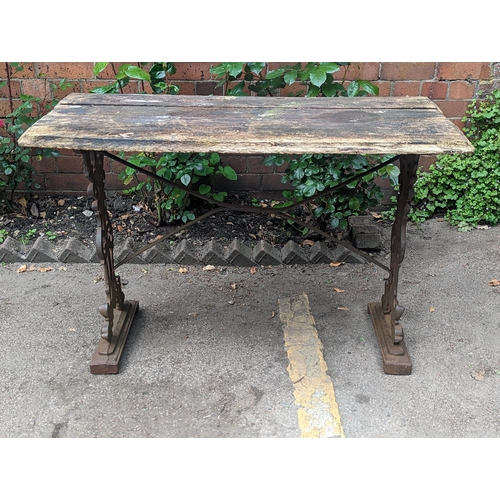 65 - A Victorian cast iron rectangular pub table base having a rectangular wooden top, A/F, 70cm x 107cm,... 