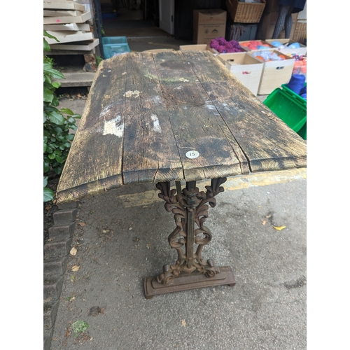 65 - A Victorian cast iron rectangular pub table base having a rectangular wooden top, A/F, 70cm x 107cm,... 