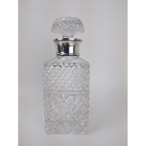 100 - A Mills & Hersey glass spirits decanter with a silver collar, London 1973, with line cut decoration,... 